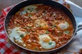 Tasty and Healthy Shakshuka in a Frying Pan on colorful towel Royalty Free Stock Photo