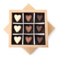 Tasty heart shaped chocolate candies in box isolated on white, top view. Valentine`s day celebration Royalty Free Stock Photo