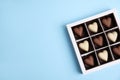 Tasty heart shaped chocolate candies on light blue background, top view with space for text. Happy Valentine`s day Royalty Free Stock Photo