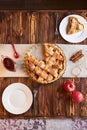 Eating sweet food context. Traditional holidays apple pie, slice on white plate and apples. Relishing sweet treats Royalty Free Stock Photo