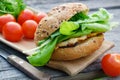 Tasty homemade burger with meat, lettuce, tomatoes, bun on picnic table outdoors Royalty Free Stock Photo