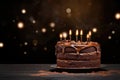 Tasty homemade chocolate pie on table. Peanut and caramel cake with chocolate topped on white plate on dark background