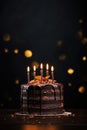 Tasty homemade chocolate pie on table. Peanut and caramel cake with chocolate topped on white plate on dark background