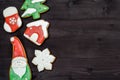 Tasty homemade gingerbread cookies with icing on dark wooden table, top view, flat lay. Christmas background. Royalty Free Stock Photo