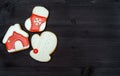 Tasty homemade gingerbread cookies with icing on dark wooden table, top view, flat lay. Christmas background with mitten. Royalty Free Stock Photo