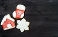 Tasty homemade gingerbread cookies with icing on dark wooden table, top view, flat lay. Christmas background with snowflake. Royalty Free Stock Photo