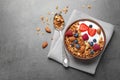 Tasty homemade granola  served on grey table, flat lay. Healthy breakfast Royalty Free Stock Photo