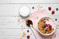 Tasty homemade granola served on wooden table, flat lay. Healthy breakfast Royalty Free Stock Photo