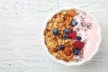 Tasty homemade granola served on white wooden table, top view. Healthy breakfast Royalty Free Stock Photo