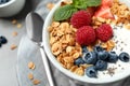 Tasty homemade granola with yogurt and berries on table, closeup. Healthy breakfast Royalty Free Stock Photo