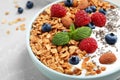 Tasty homemade granola with yogurt and berries on grey table, closeup. Healthy breakfast