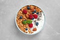 Tasty homemade granola with yogurt and berries on grey table, top view. Healthy breakfast Royalty Free Stock Photo