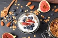 Tasty homemade granola with yogurt on grey table, flat lay. Healthy breakfast Royalty Free Stock Photo