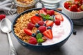 Tasty homemade granola with yogurt on grey table. Healthy breakfast Royalty Free Stock Photo