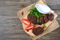 Tasty homemade liver cutlets stacked on a wooden board. The top view