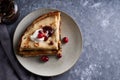 Tasty homemade pancakes with cranberries and sour cream served on gray stone table Copy space Top view