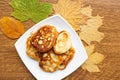 Tasty homemade pancakes and maple leafs on the table, top view. Warm golden autumn concept.