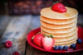 Tasty homemade pancakes with strawberries, blueberries and maple Royalty Free Stock Photo