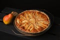 Tasty homemade pear pie on wooden background