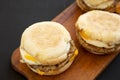 Tasty homemade pork roll egg sandwich on a rustic wooden board on a black background, side view. Close-up Royalty Free Stock Photo