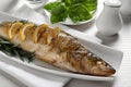 Tasty homemade roasted pike perch served on white wooden table, closeup. River fish