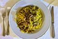 Tasty homemade tagliatelle pasta with fresh harvested boletus porcini mushrooms in creamy sauce