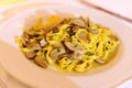 Tasty homemade tagliatelle pasta with fresh harvested boletus porcini mushrooms in creamy sauce