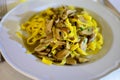 Tasty homemade tagliatelle pasta with fresh harvested boletus porcini mushrooms in creamy sauce