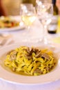 Tasty homemade tagliatelle pasta with fresh harvested boletus porcini mushrooms in creamy sauce