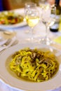 Tasty homemade tagliatelle pasta with fresh harvested boletus porcini mushrooms in creamy sauce