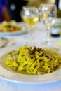 Tasty homemade tagliatelle pasta with fresh harvested boletus porcini mushrooms in creamy sauce