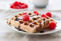 Tasty homemade waffles with raspberries and chocolate sauce ready for breakfast Royalty Free Stock Photo