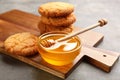 Tasty honey and cookies on grey table