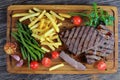 Tasty hot beef steaks with vegetables Royalty Free Stock Photo