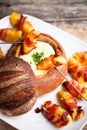 Tasty hot cheese fondue served in a bread roll with potatoes and Royalty Free Stock Photo