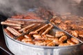 Tasty hot grilled sausages, chicken wings and barbecue in street market ready to eat Royalty Free Stock Photo