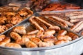 Tasty hot grilled sausages, chicken wings and barbecue in street market ready to eat Royalty Free Stock Photo