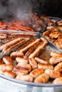 Tasty hot grilled sausages, chicken wings and barbecue in street market ready to eat Royalty Free Stock Photo