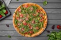 Tasty hot italian pizza with arugula, cherry tomatoes, cheese. Pizzeria menu. Concept poster for Restaurants or pizzerias Royalty Free Stock Photo