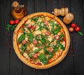 Tasty hot italian pizza on black wooden table. Royalty Free Stock Photo