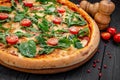 Tasty hot italian pizza on black wooden table. Royalty Free Stock Photo