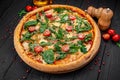 Tasty hot italian pizza on black wooden table Royalty Free Stock Photo