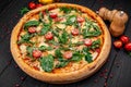 Tasty hot italian pizza on black wooden table Royalty Free Stock Photo