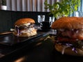 Tasty huge burgers in a restaurant - at a table Royalty Free Stock Photo