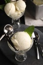 Tasty ice cream with vanilla pods in glass dessert bowls on dark grey table, above view Royalty Free Stock Photo