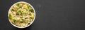 Tasty instant noodles with beef flavoring in a cup over black background, top view. Flat lay, from above, overhead. Space for text