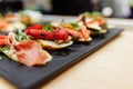 Tasty italian appetizer bruschettes with tomatoes anchovies prosciutto, mozarella, shrimps and seafood Royalty Free Stock Photo