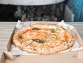 Tasty Italian oven baked pizza in delivery box