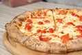 Tasty Italian oven baked pizza on wooden table