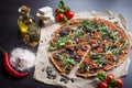 Tasty italian pizza on dark wooden table top view Royalty Free Stock Photo